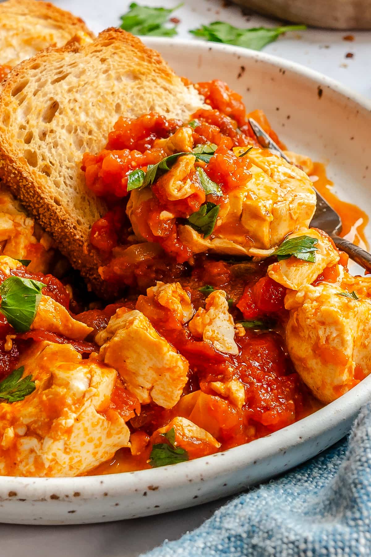 A close up of silken tofu vegan shakshuka on a plate with toast.