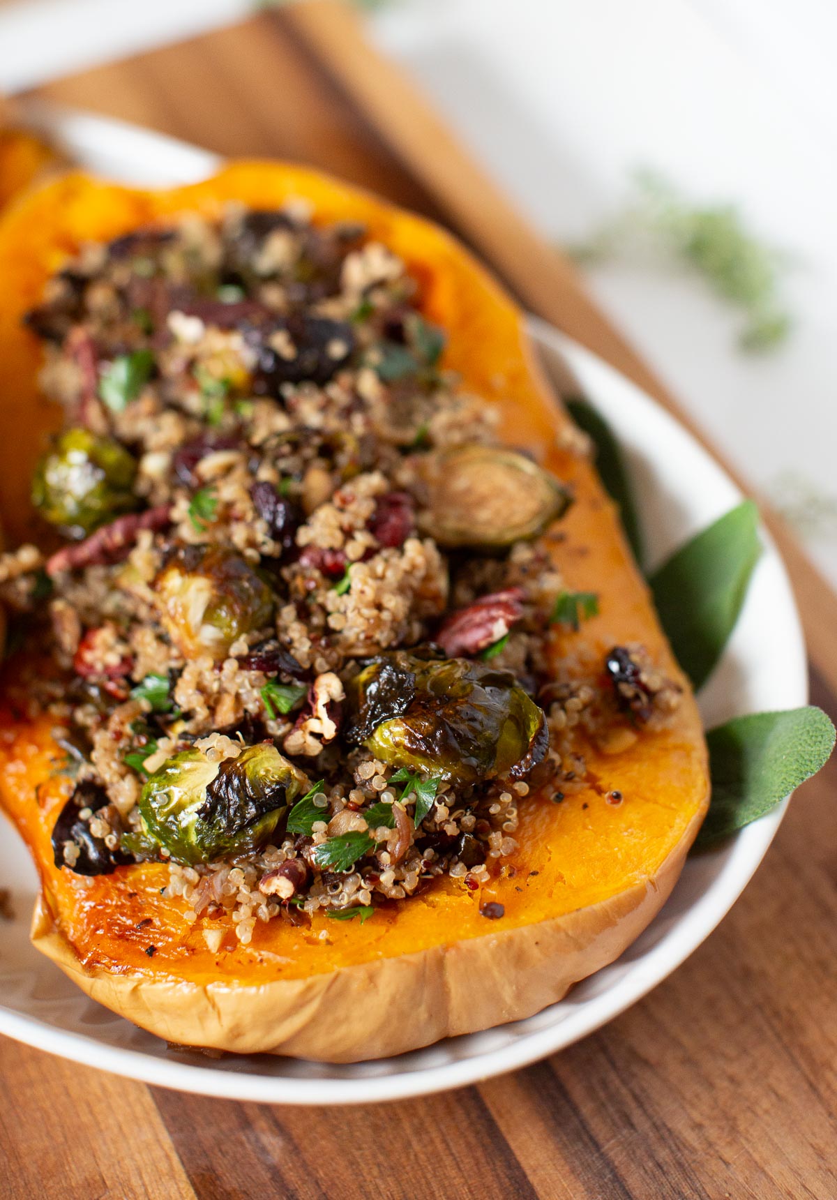 Stuffed butternut squash with quinoa filling and fresh herbs.